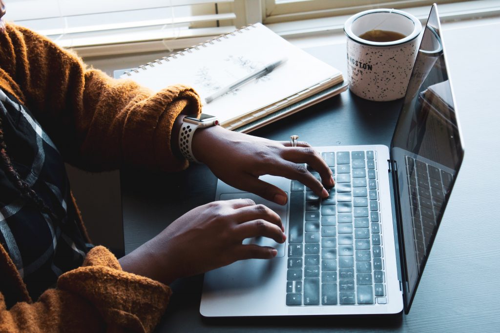 woman typing on laptop