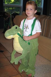 boy with stuffed dinosaur
